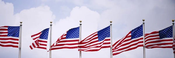 American Flags: Low angle view of American flags fluttering in wind by Panoramic Images
