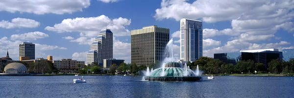 Fountains: Buildings at the waterfront, Lake Eola, Orlando, Florida, USA by Panoramic Images