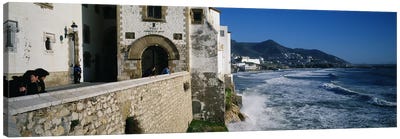 Tourists in a church beside the sea, Sitges, Spain Canvas Art Print - Coastal Village & Town Art