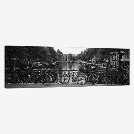 Bicycle Leaning Against A Metal Railing On A Bridge, Amsterdam, Netherlands Canvas Print #PIM3807} by Panoramic Images Canvas Art Print