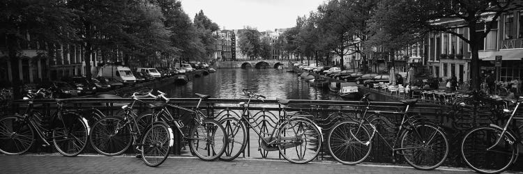 Bicycle Leaning Against A Metal Railing On A Bridge, Amsterdam, Netherlands by Panoramic Images wall art