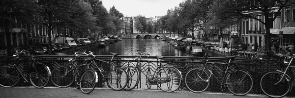 Amsterdam: Bicycle Leaning Against A Metal Railing On A Bridge, Amsterdam, Netherlands by Panoramic Images