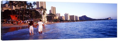 Rear view of a couple wading on the beach, Waikiki Beach, Honolulu, Oahu, Hawaii, USA Canvas Art Print - Hawaii Art