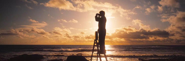 Man Looking Through Binoculars In Silhouette by Panoramic Images wall art