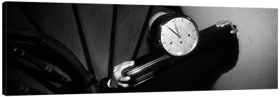 Man Carrying Clock Up Stairs on Shoulders Canvas Art Print - Black & White Art