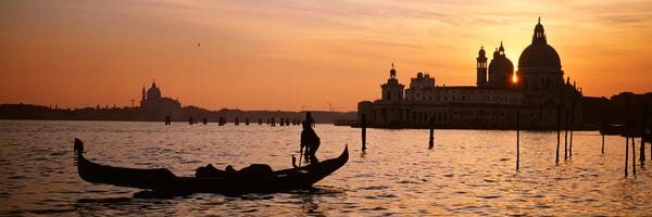 Veneto: Silhouette of a gondola in a canal at sunset, Santa Maria Della Salute, Venice, Italy by Panoramic Images