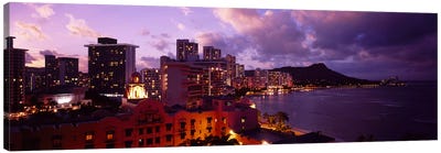 Buildings lit up at dusk, Waikiki, Oahu, Hawaii, USA Canvas Art Print - Waikiki