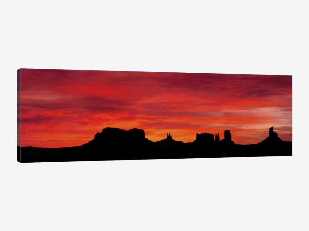 Silhouette Of Monument Valley's Buttes Across A Deep Orange Sunset by Panoramic Images 1-piece Canvas Wall Art