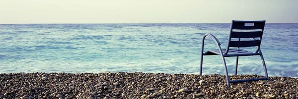 Rocky Beaches: Vacant Chair On The Beach, Nice, Cote De Azur, France by Panoramic Images