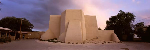 Taos: Overcast clouds sky over a church, San Francisco de Asis Church, Ranchos De Taos, New Mexico, USA by Panoramic Images