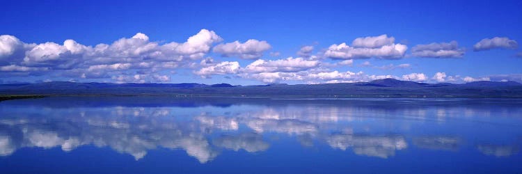 Fluffy Clouds And Their Reflections In The Olfusa, Iceland