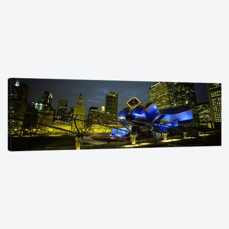 Low angle view of buildings lit up at night, Pritzker Pavilion, Millennium Park, Chicago, Illinois, USA Canvas Print #PIM5452} by Panoramic Images Canvas Art Print