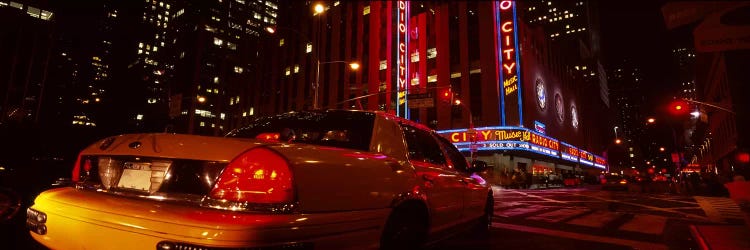 Car on a road, Radio City Music Hall, Rockefeller Center, Manhattan, New York City, New York State, USA by Panoramic Images wall art