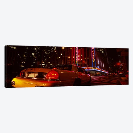 Car on a road, Radio City Music Hall, Rockefeller Center, Manhattan, New York City, New York State, USA Canvas Print #PIM5455} by Panoramic Images Canvas Wall Art