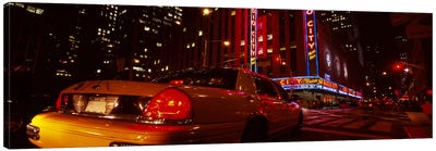 Car on a road, Radio City Music Hall, Rockefeller Center, Manhattan, New York City, New York State, USA Canvas Art Print