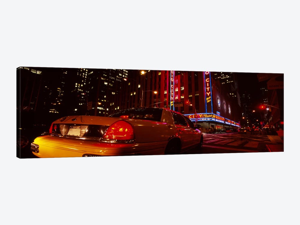 Car on a road, Radio City Music Hall, Rockefeller Center, Manhattan, New York City, New York State, USA by Panoramic Images 1-piece Art Print