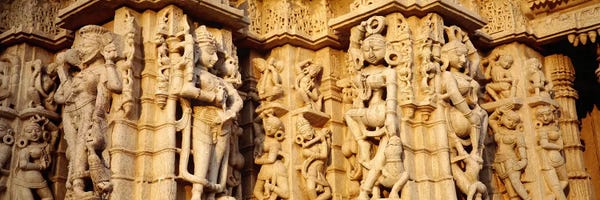 India: Sculptures carved on a wall of a temple, Jain Temple, Ranakpur, Rajasthan, India by Panoramic Images