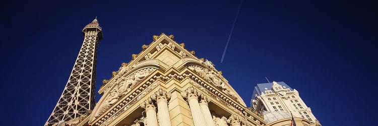 Low angle view of a building in front of a replica of the Eiffel Tower, Paris Hotel, Las Vegas, Nevada, USA