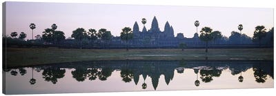 Reflection of temples and palm trees in a lake, Angkor Wat, Cambodia Canvas Art Print - Cambodia