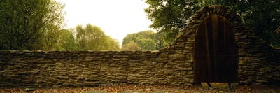 Wooden Door In An Arch Along A Stone Wall, County Kilkenny, Leinster Province, Republic Of Ireland by Panoramic Images canvas print