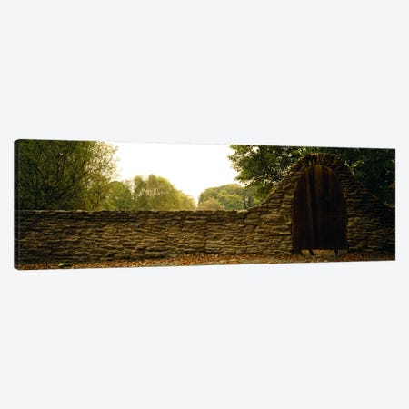 Wooden Door In An Arch Along A Stone Wall, County Kilkenny, Leinster Province, Republic Of Ireland Canvas Print #PIM5706} by Panoramic Images Canvas Wall Art