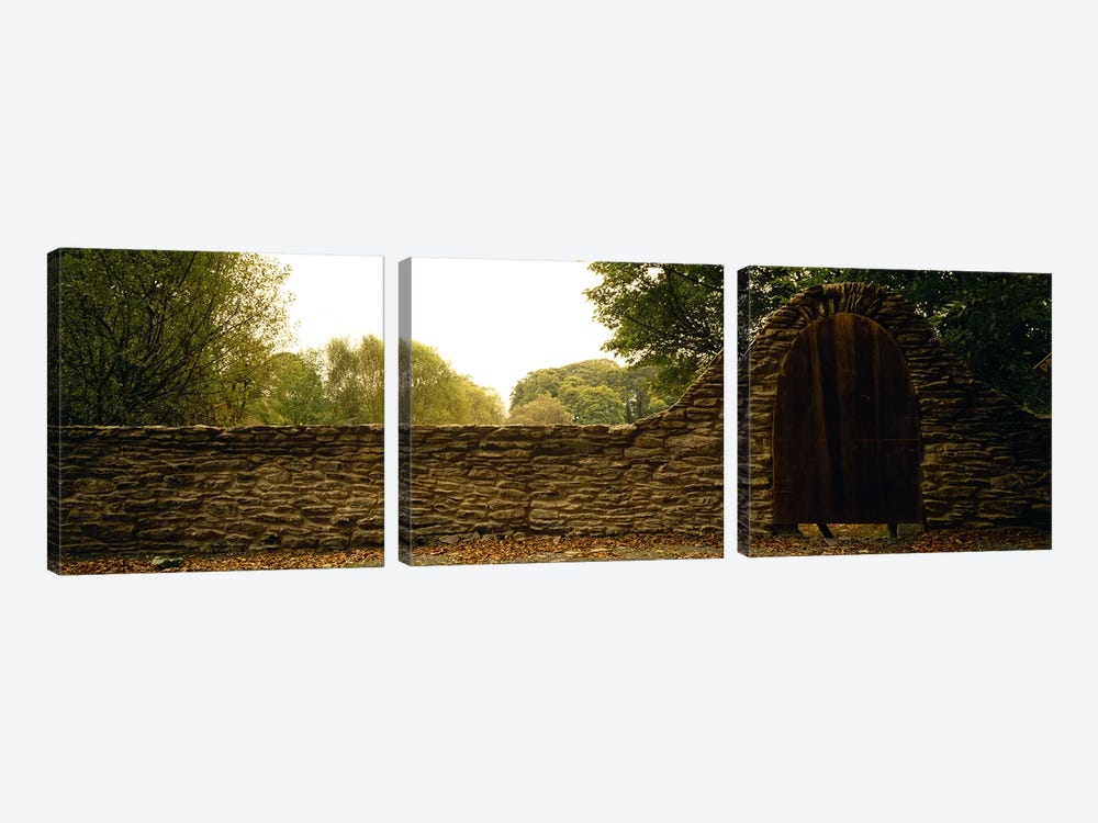 Wooden Door In An Arch Along A Stone Wall, County Kilkenny, Leinster Province, Republic Of Ireland by Panoramic Images 3-piece Canvas Print