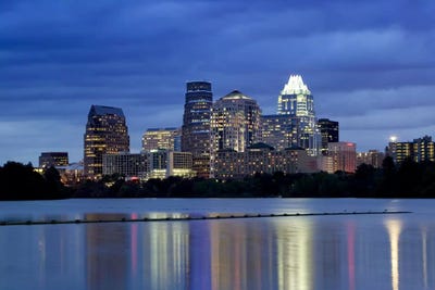 Buildings at the waterfront lit up at dusk, Town Lake, Austin, Texas, USA by Panoramic Images gallery poster
