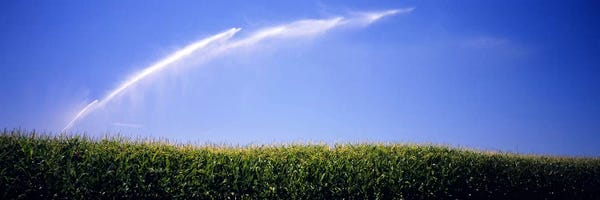 Water being sprayed on a corn field, Washington State, USA