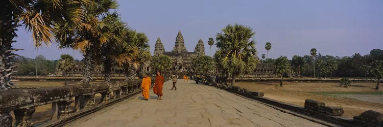 Two monks walking in front of an old temple, Angkor Wat, Siem Reap, Cambodia