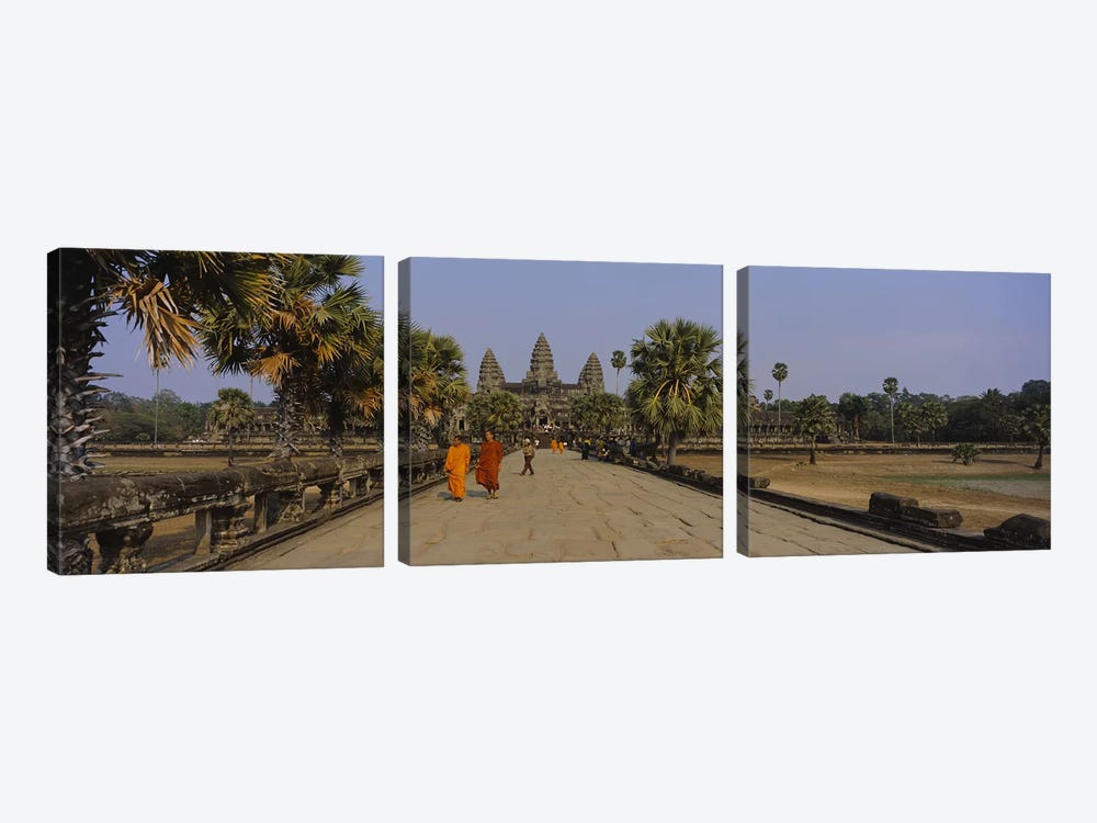 Two monks walking in front of an old temple, Angkor Wat, Siem Reap, Cambodia by Panoramic Images 3-piece Canvas Print