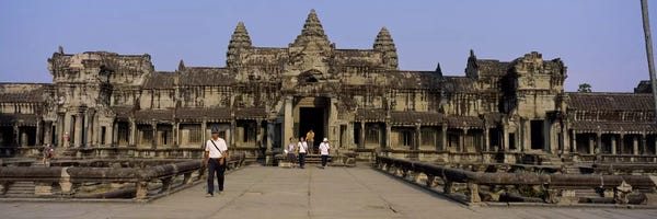 Angkor Wat: Tourists walking in front of an old temple, Angkor Wat, Siem Reap, Cambodia by Panoramic Images