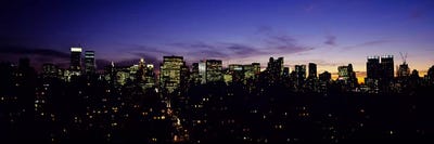Skyscrapers in a city lit up at night, Manhattan, New York City, New York State, USA by Panoramic Images canvas print