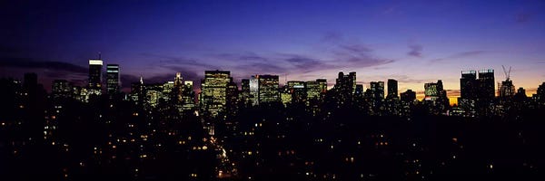 New York City Skylines: Skyscrapers in a city lit up at night, Manhattan, New York City, New York State, USA by Panoramic Images