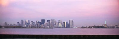 Skyscrapers & a statue at the waterfront, Statue of Liberty, Manhattan, New York City, New York State, USA by Panoramic Images canvas print