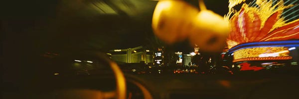 Nevada: Buildings lit up at night viewed through a car, Las Vegas, Nevada, USA by Panoramic Images
