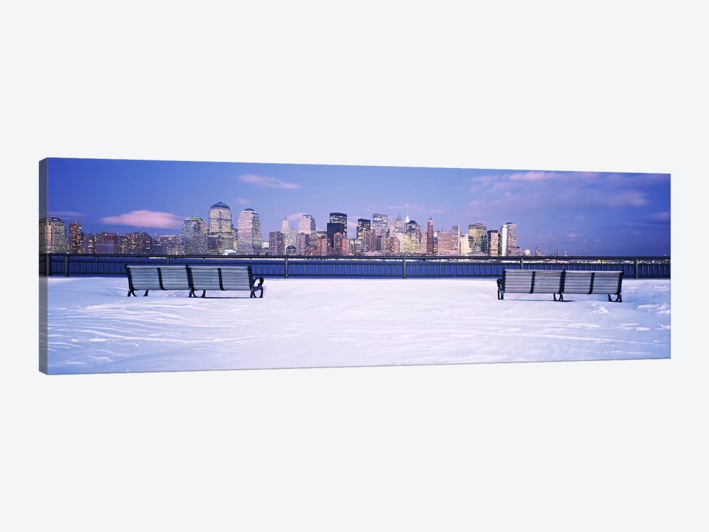 Park benches in snow with a city in the background, Lower Manhattan, Manhattan, New York City, New York State, USA by Panoramic Images 1-piece Canvas Artwork