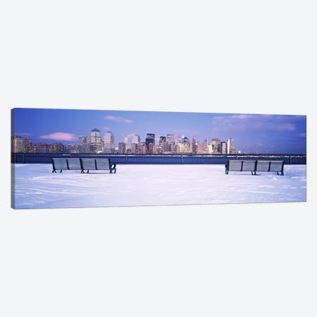 Park benches in snow with a city in the background, Lower Manhattan, Manhattan, New York City, New York State, USA Canvas Print #PIM6333} by Panoramic Images Canvas Wall Art