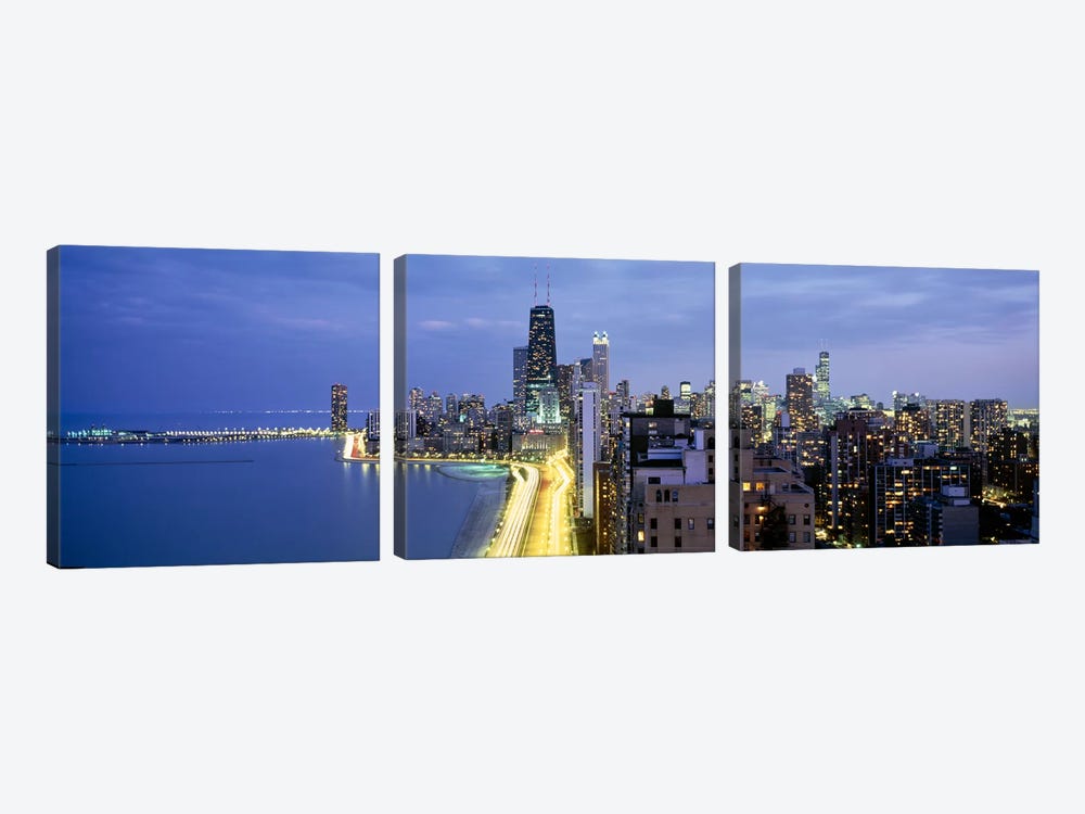 Skyscrapers lit up at the waterfront, Lake Shore Drive, Chicago, Cook County, Illinois, USA by Panoramic Images 3-piece Canvas Print