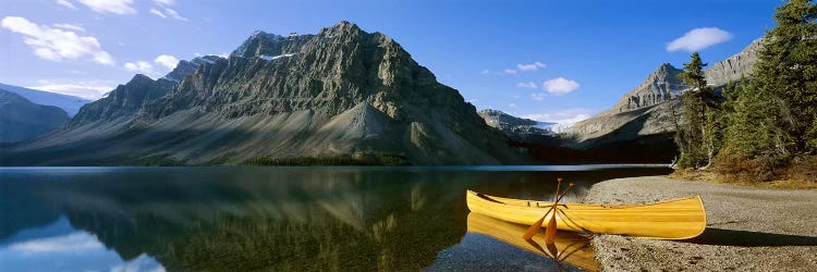 Crowfoot Mountain With A Lone Canoe On The Shore Of Bow Lake, Banff National Park, Alberta, Canada