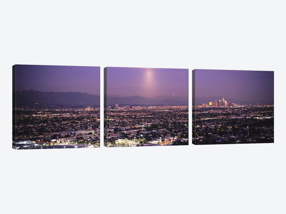 Buildings in a city lit up at dusk, Hollywood, San Gabriel Mountains, City Of Los Angeles, Los Angeles County, California, USA by Panoramic Images 3-piece Canvas Print