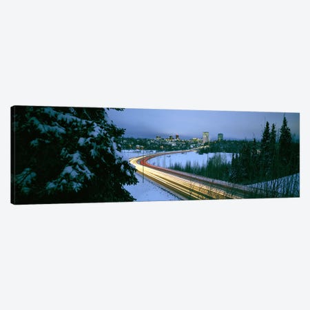 Autumobile lights on busy street, distant city lights, frozen Westchester Lagoon, Anchorage, Alaska, USA. Canvas Print #PIM6726} by Panoramic Images Canvas Art