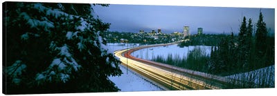 Autumobile lights on busy street, distant city lights, frozen Westchester Lagoon, Anchorage, Alaska, USA. Canvas Art Print - Alaska Art