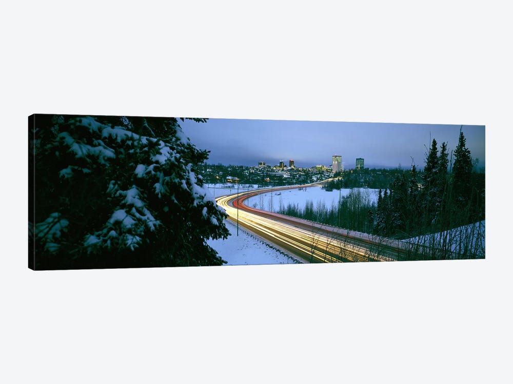 Autumobile lights on busy street, distant city lights, frozen Westchester Lagoon, Anchorage, Alaska, USA. by Panoramic Images 1-piece Art Print