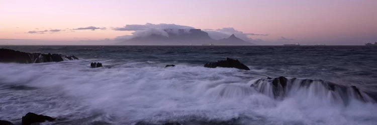 Waves Crashing Over Rocky Outcrops With Table Mountain In The Background, Cape Town, Western Cape, South Africa