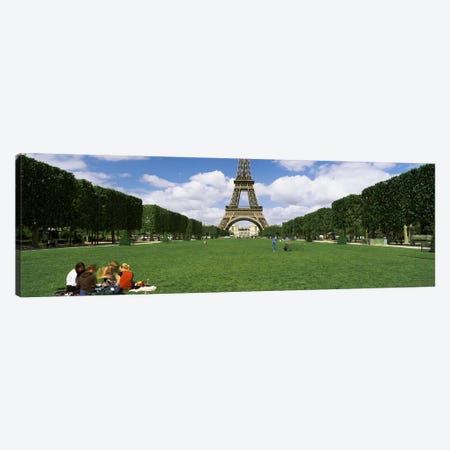Tourists sitting in a park with a tower in the background, Eiffel Tower, Paris, Ile-de-France, France Canvas Print #PIM7020} by Panoramic Images Art Print