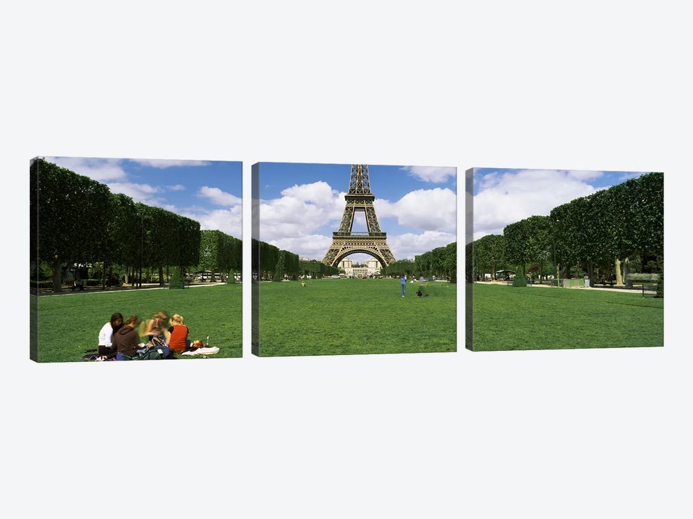 Tourists sitting in a park with a tower in the background, Eiffel Tower, Paris, Ile-de-France, France by Panoramic Images 3-piece Canvas Artwork