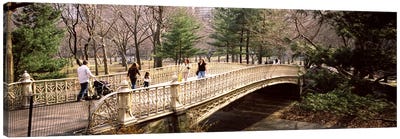 Group of people walking on an arch bridgeCentral Park, Manhattan, New York City, New York State, USA Canvas Art Print - Bridge Art