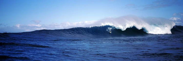 Distant View Of A Surfer On A Cresting Ocean Wave