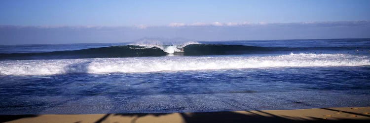 Distant View Of A Lone Surfer On A Cresting Wave, North Shore, Oahu, Hawaii, USA