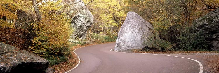 Road curving around a big boulder, Stowe, Lamoille County, Vermont, USA